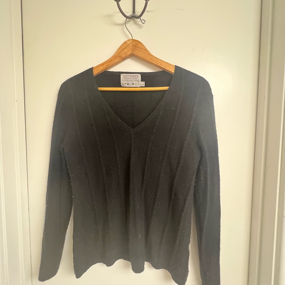 Black V-neck, cashmere sweater with small cabling detail.
